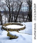 Small photo of DUBUQUE, IOWA, February 6, 2022–Landscape photo of beautiful snow covered limestone council ring on winter day at Eagle Point Park.