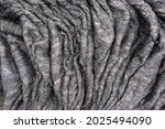 Small photo of Natural background from solidified volcanic lava. Rope lava is the result of slowing forward flow and accelerating backward flow. Crumpled volcanic stones of Kamchatka Russia