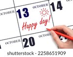 13th day of October. Hand writing the text HAPPY DAY and drawing the sun on the calendar date October 13. Save the date. Holiday. Motivation. Autumn month, day of the year concept.