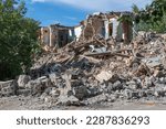 Small photo of Landscape of ruined buildings, image of decrepitude or natural disaster. The house is destroyed. Destruction of old houses, earthquakes, economic crisis, abandoned houses. Broken unfit house