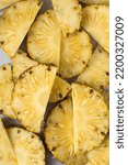Small photo of Sliced ripe pineapple, flatlay view of cut pineapple, top view of ripe pineapple, cross section of pineapple fruit