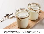 Homemade Greek yogurt in a glass jars ready to eat. Healthy breakfast.