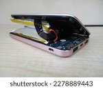 Lithium-ion battery on powerbank, which has expanded. Broken battery, Lithium polymer battery swollen dangerous to explode and catch on fire, Damaged power bank.