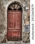 Small photo of Image of a single door dating back to the 19th century or earlier, photographed in a medieval village in the Ligurian hinterland, Italy.