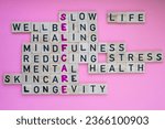 Small photo of Top view of SELFCARE word on pink background. Minimalism creative crossword puzzle concept. Message of text Slow life wellbeing healing mindfulness reducing stress mental health skincare longevity