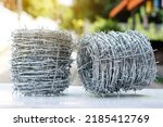 Small photo of Rolls of barbed wire. Barbed wire is used for make fences , secure property and make border to show the territory of area.