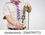 Small photo of Tying rope knot pattern, demonstrated by scout teacher trainer. Concept, useful tying knot for many purposes in daily life. Tying knot rope teaching aid. Life skills with rope.