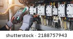 Small photo of Electricity and electrical maintenance service, Engineer hand holding AC multimeter checking electric current voltage at circuit breaker terminal and cable wiring main power distribution board.