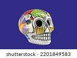 Small photo of Beautiful and colorful Mexican skull isolated, made of ceramic, and painted by hand. Craft made in Mexico. Purple background. Traditional mexican skull for the Day of the Deads.