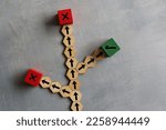 Small photo of Wooden cubes with arrows, right and wrong icon. Choosing right path, road to success, alternative option concept