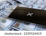 Small photo of Kedah, Malaysia- July 30th 2023: Social networking service X app logo on smartphone and money. Twitter rebrand as X. Revenue, business and profit concept