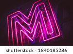 Small photo of Restaurant sign decorate neon color red and purple are denoted to the letter M.