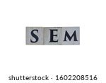 Wooden cubes showing the abbreviation SEM (Search Engine Marketing) with white background, for designs and layouts