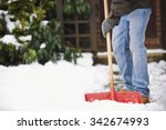 Man Clearing Snow From Path With Shovel