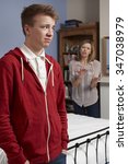 Small photo of Teenage Boy Being Told Off By Mother