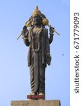 Small photo of High statue of the Indian deity Shani with raised hand. Monument to the planet's Saturn lord, the most impartial god in hinduism, symbol of justice