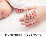 Hand the sleeping baby in the hand of mother close up, New family and baby protection from mom concept