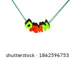 Small photo of Damn word text spelling by wooden green and red letters hanging, strung on a lace as bracelet, necklace, emotional expression, reaction, expletive concept