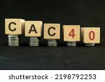 Small photo of French CAC 40 stock market index crash and bear market due to financial crisis and recession in France. Wooden blocks in with coins in dark black background.