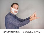 Small photo of man showing the gesture of help along with a deaf-mute mask