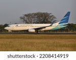 Small photo of Boyolali, Central Java, Indonesia-February 11, 2018: Garuda Indonesia, PK-GNU, Boeing 737-800, backtrack taxi to runway 26 of Adi Soemarmo Airport