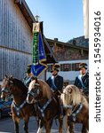 Small photo of Bavarian Townsfolk in traditional outfits riding their horses in the annual Leonhardi Ritt. In Upper Bavaria Unterammergau/Bavaria/Germany 10/27/2019