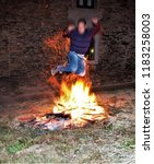 Small photo of countrymen jumping the bonfire on the night of San Juan in Galicia,traditional bonfire of San Juan, tourism, tourist, advertising, tourist destination, holidays, travel, travelers, happiness