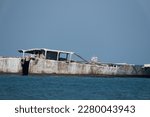 Concrete ships line the outer area of Kiptopeke beach and pier in Virginia. The remnants of WW II ships help protect the shoreline and formerly protected the ferry lanes in the bay.