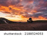 Tourist camper car parked with beautiful sunset sky on top of mountain in Icelandic Highlands on summer at Iceland