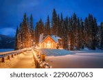 Small photo of Beautiful view of Emerald Lake with wooden lodge glowing in snowy pine forest on winter at Yoho national park, Alberta, Canada