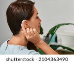 Small photo of Adult woman with hearing aid behind the ear can hear sounds. Hearing loss treatment concept and hearing solutions for people with deafness