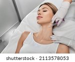 Smoothing female neck skin with injections in neck at cosmetic clinic. Neck skin rejuvenation and contouring, mesotherapy and biorevitalization