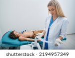Small photo of Pediatrician looking ECG printout of child patient after heart electrocardiogram procedure at medical clinic