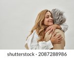 Happy loving young grownup daughter embrace mature mom show care and gratitude. Smiling adult woman child hug senior mother feel thankful grateful. Motherhood, family unity concept.
