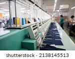 Modern and automatic high technology embroidery machine for textile or clothing apparel making manufacturing process in industrial. Close up Computerized embroidery machines. Digital textile industry.
