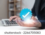 Small photo of Businessman using laptop with verification account blue tick checkmark concept, verification account on social media platform, subscription status, eliminate bots, spam.