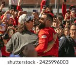 Small photo of Kansas City, MO, USA - February 14, 2024: Travis Kelce, who plays the tight end position for the Kansas City Chiefs NFL football team interacts with many fans during the Super Bowl LVIII Parade