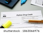 Small photo of Financial concept about Form 8820 Orphan Drug Credit with sign on the piece of paper.