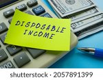 Small photo of Business concept about DISPOSABLE INCOME with sign on the sheet.