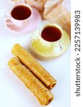 Small photo of Homemade apple pastille. Healthy food without sugar. The pastille is rolled into a tube. Vertical photo.