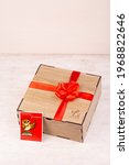 Small photo of Moscow, Russia - 08172020: gift box with postcard, wood, red banter