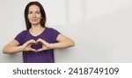 Small photo of Inspire inclusion. Zoomers symbolize love. Woman finger heart dressed purple t-shirt. Hand showing heart. International Women's Day 2024 banner, inspireInclusion.