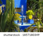 Vibrant blue fountain at the exotic and colorful Majorelle Garden / Jardin de Majorelle on the outskirts of Marrakech, Morocco 