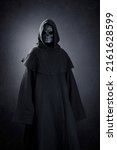 Small photo of Grim reaper over dark misty background