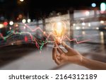 Energy crisis, Hand hold light bulb with energy resources icon and rising data chart representing electricity crisis, Economy   and alternative energy, Sustainability. Ecological friendly. 