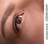 Small photo of permanent eyeliner makeup close up. Healthy and clean skin young woman
