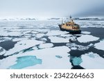 Small photo of Expedition vessel cruising through sea ice in Svalbard