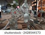 Small photo of Singapore, Singapore - November 13, 2023: Changi Airport in Singapore , Travelling Family is an aluminium sculpture by renowned Swiss artist, Kurt Laurenz Metzler.