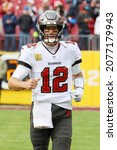 Small photo of Nov 14, 2021; Landover, MD USA; Tampa Bay Buccaneers quarterback Tom Brady (12) runs out to the field before an NFL game at FedEx Field. (Steve Jacobson, Image of Sport)