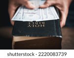 Small photo of One tenth or tithe is basis on which Bible teaches us to give one tenth of first fruit to God. coins with Holy Bible. Biblical concept of Christian offering, generosity, and giving tithes in church.